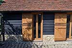 European oak narrow french doors with ledged and braced stable doors infront copper capping to lower stable door