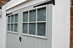 Painted hardwood garage doors with glazing