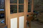 Paneled door with glazed upper side light on frame